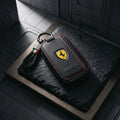 Ferrari key fob with leather cover on dark slate