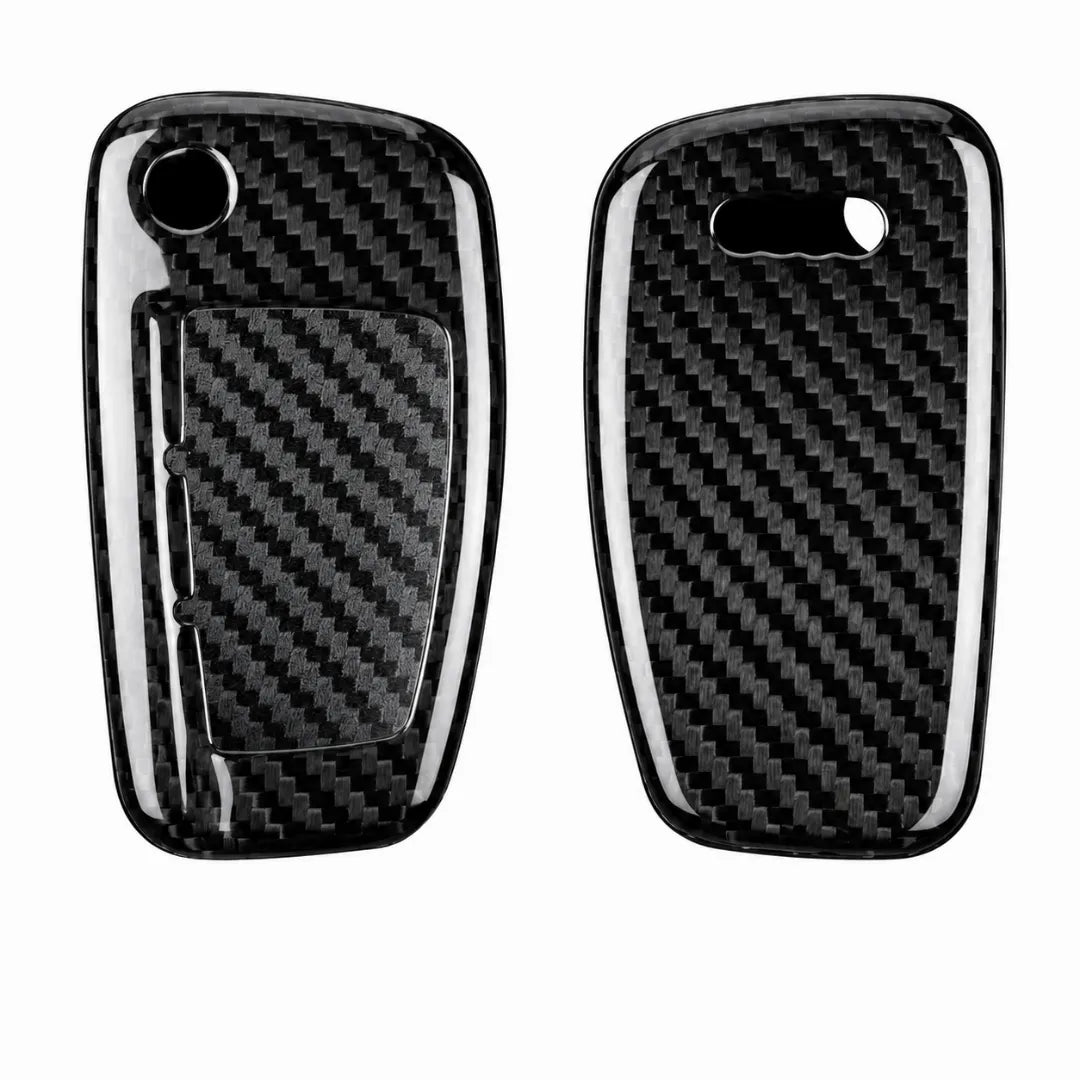 Two glossy carbon fiber key fob covers shown side by side on a plain white background, with a black-and-white woven carbon fiber pattern and cutouts for the key fob buttons.