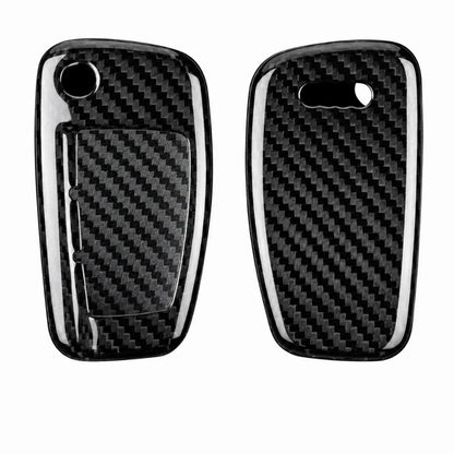 Two glossy carbon fiber key fob covers shown side by side on a plain white background, with a black-and-white woven carbon fiber pattern and cutouts for the key fob buttons.
