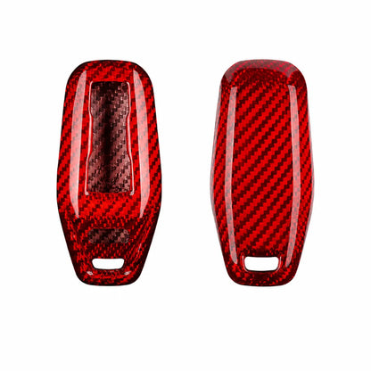 Two glossy red carbon fiber textured key fob covers shown side by side on a plain white background.