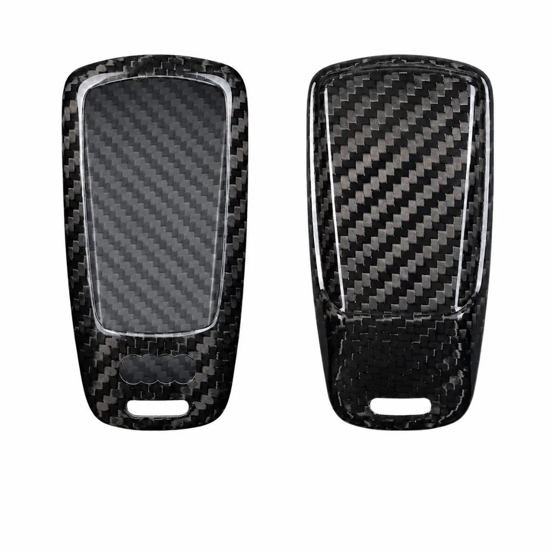 Two black carbon fiber key fob covers shown from the front and back, featuring a glossy woven carbon fiber pattern and a clear protective film on the left side, set against a plain white background.
