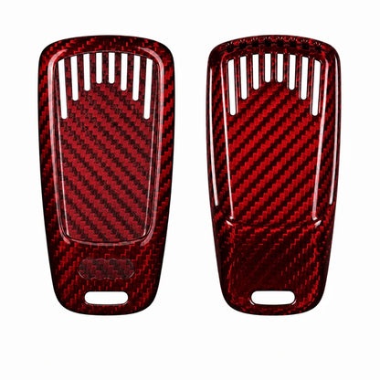 A pair of red carbon fiber textured key fob covers with a glossy finish, displayed side-by-side on a plain white background.