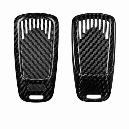 Two black carbon fiber textured car key fob pieces with a glossy woven pattern, shown side by side on a plain white background.