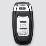 Original black Audi 3-button oval smart key fob featuring top chrome accent loop