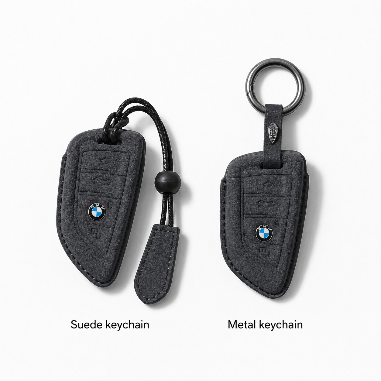 Two BMW keychain covers shown side by side on a light gray background: a suede keychain on the left with a black cord and bead, and a metal keychain on the right with a round key ring. Text below labels them 'Suede keychain' and 'Metal keychain'.
