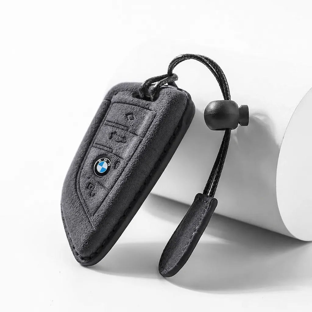 Suede key fob cover for BMW with keychain on a white background