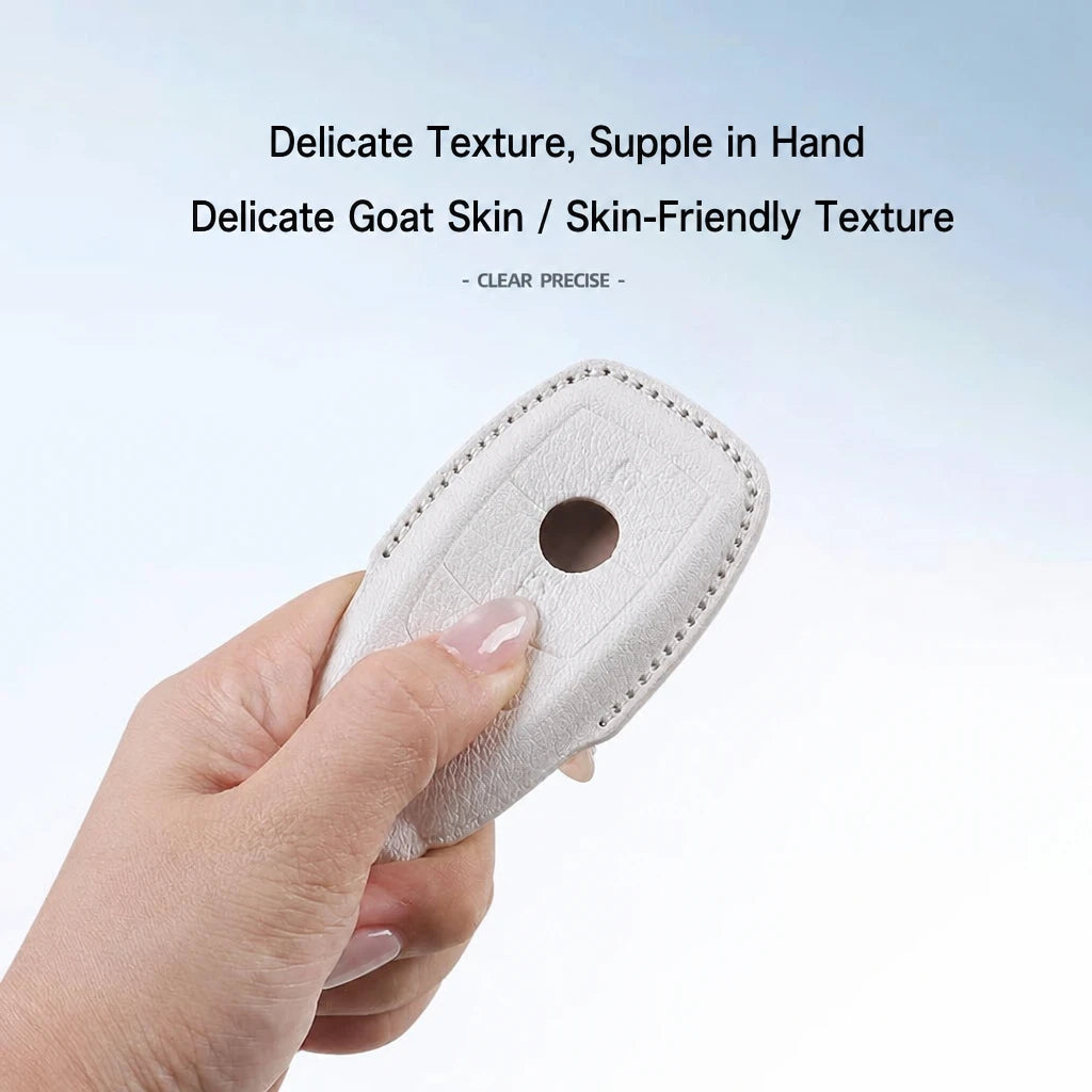A hand holding a small beige textured leather or goat-leather accessory with a circular cutout, against a light blue-to-white gradient background with promotional text about delicate goat skin texture.