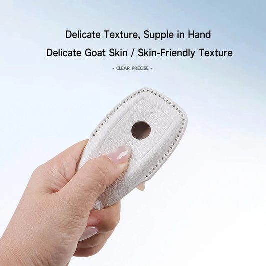 A hand holding a small beige textured leather or goat-leather accessory with a circular cutout, against a light blue-to-white gradient background with promotional text about delicate goat skin texture.