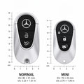 Two Mercedes-Benz key fobs shown side by side with measurement rulers and labels reading NORMAL 82MM X 41MM and MINI 70MM X 35MM, on a white background.