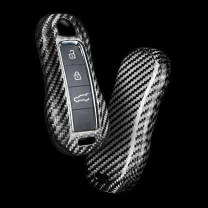 Two carbon fiber key case covers with a glossy woven pattern, shown on a solid black background.