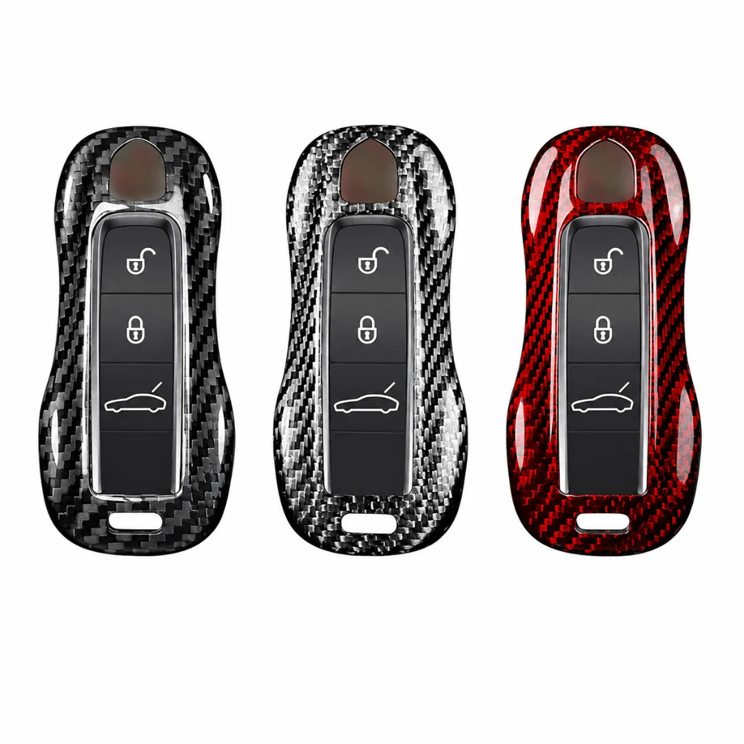 Three car key fob covers with a glossy carbon fiber pattern, shown side by side on a plain white background. The left cover is black and dark gray, the middle is black and silver, and the right is red and black.