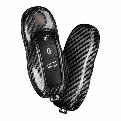 A carbon fiber textured key case cover shown on a car key fob and its matching protective shell, displayed against a solid white background.