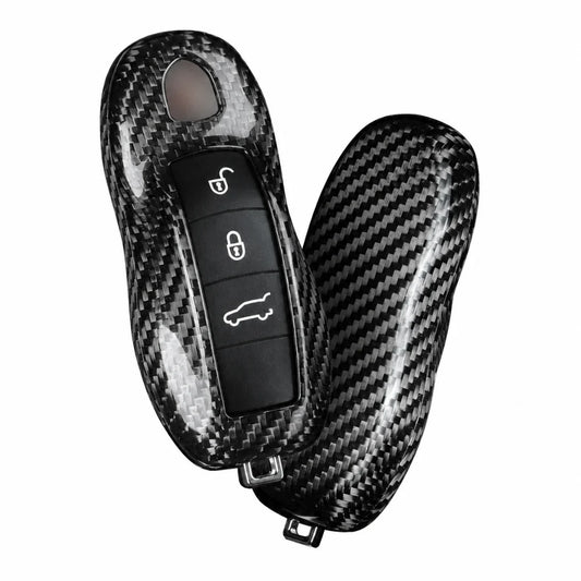 A carbon fiber textured key case cover shown on a car key fob and its matching protective shell, displayed against a solid white background.