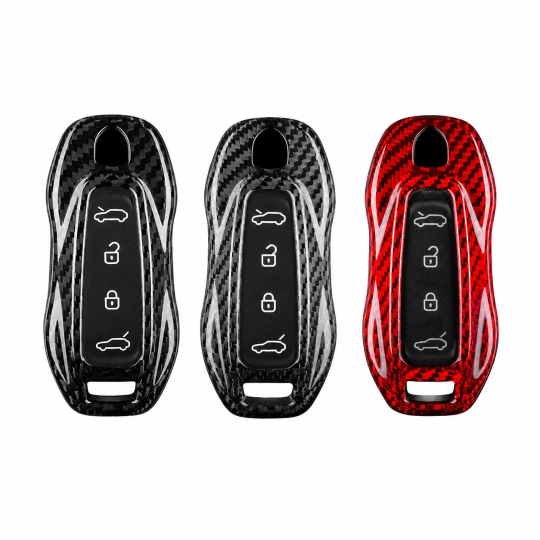 Three car key fob covers with a glossy carbon fiber pattern, shown side-by-side in black, silver, and red on a plain white background.