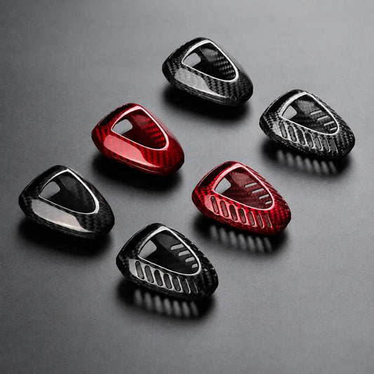 Six carbon fiber patterned protective covers in red and black, arranged on a dark gray background.