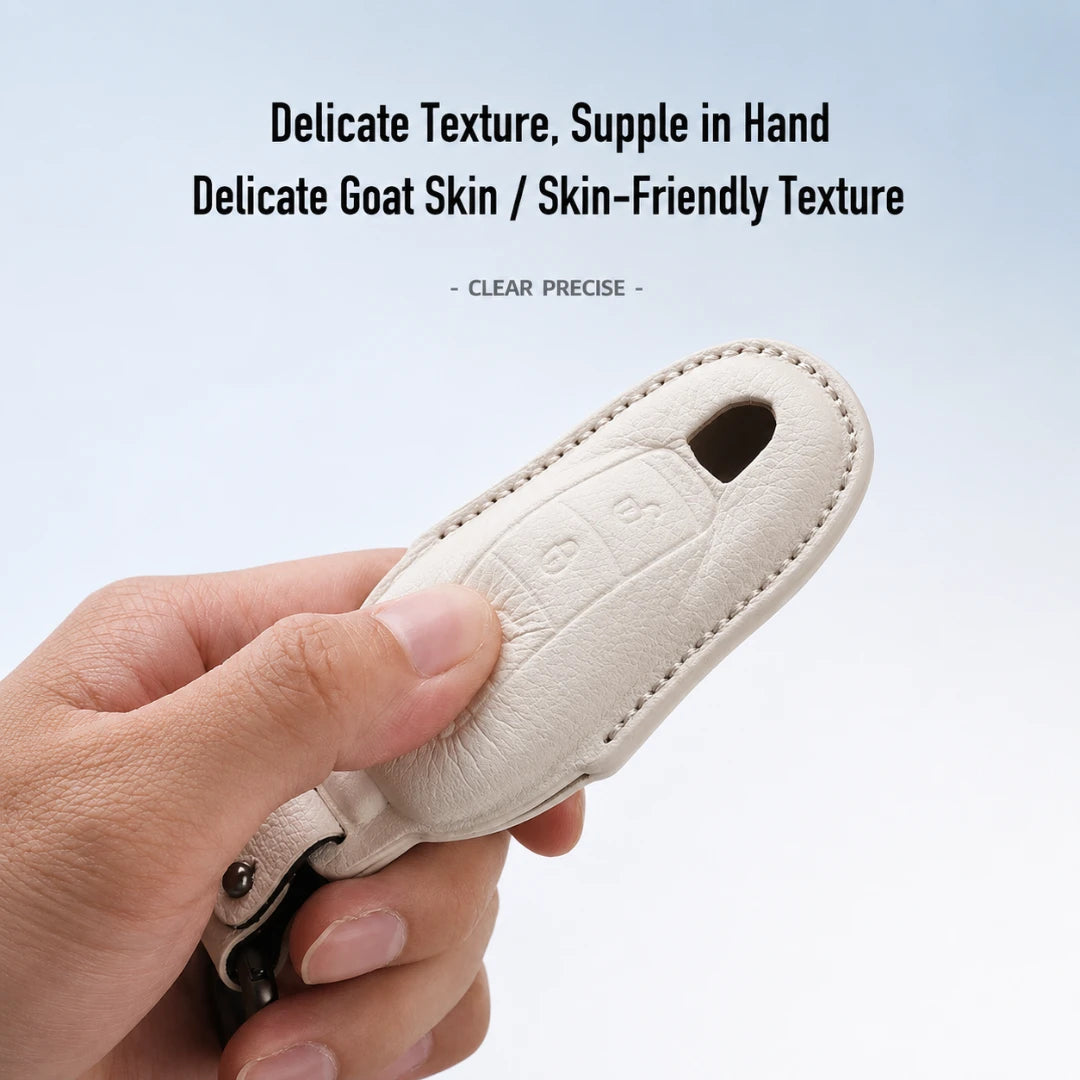 A hand holding a cream-colored leather car key fob cover with a delicate textured finish, set against a light blue gradient background with promotional text.