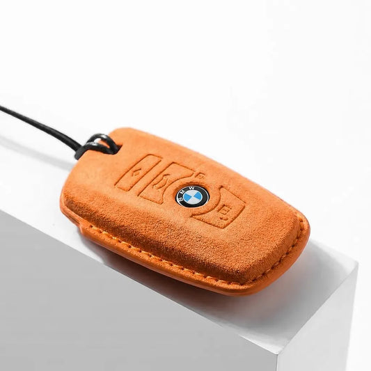 Orange BMW key fob cover on a white background