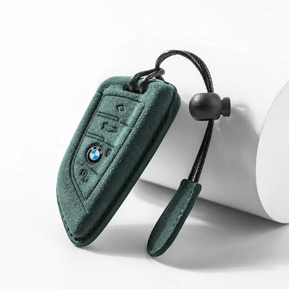 Dark Green suede car key fob cover with BMW logo on a white background